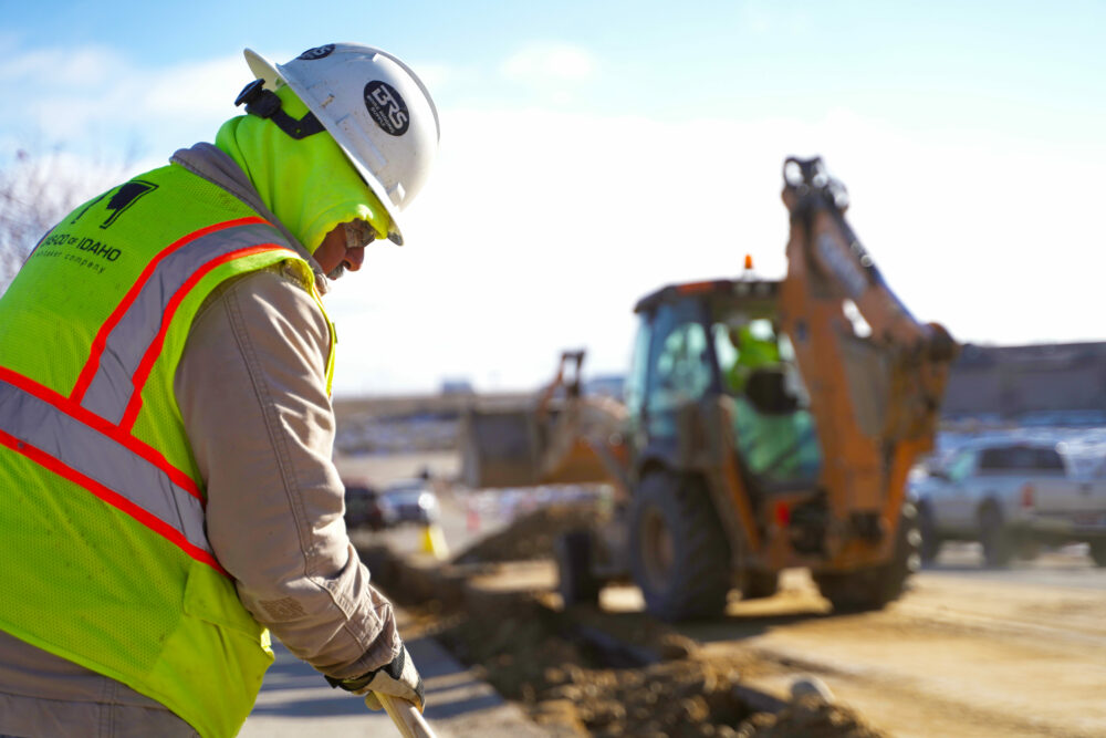 Utility Contractor Digging With A Shovel