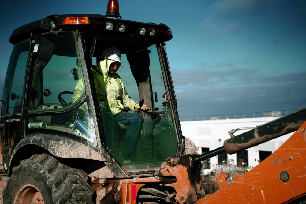 Utility Contractor Operating Backhoe